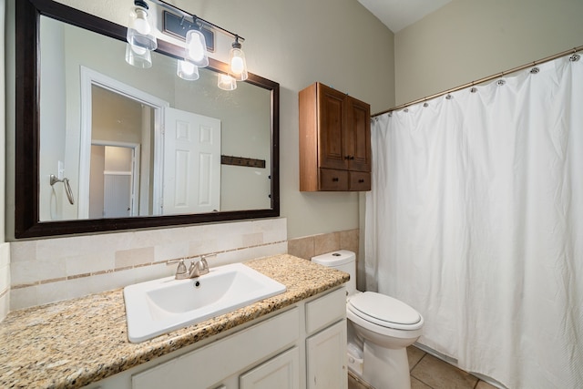 bathroom with tile patterned flooring, vanity, toilet, and tasteful backsplash