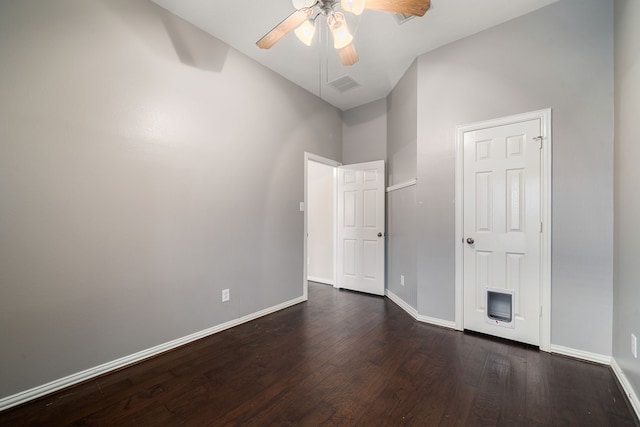 interior space with dark hardwood / wood-style floors, high vaulted ceiling, and ceiling fan