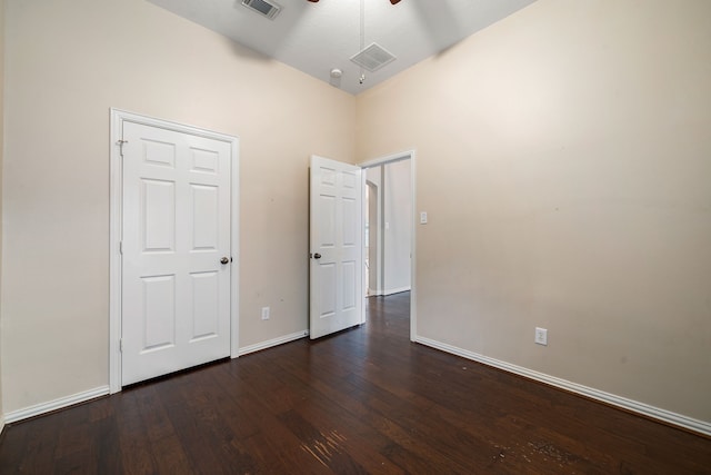 unfurnished bedroom featuring ceiling fan and dark hardwood / wood-style flooring