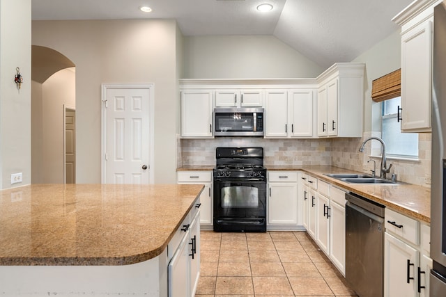 kitchen featuring sink, white cabinetry, stainless steel appliances, and vaulted ceiling