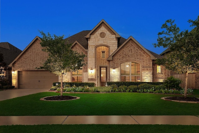 french country inspired facade featuring a garage and a front lawn