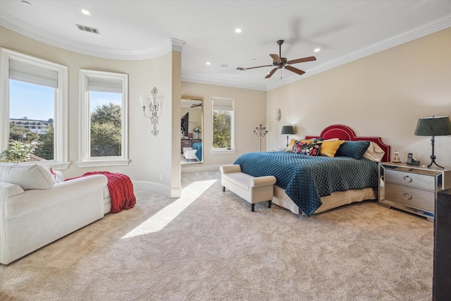 bedroom with multiple windows, ceiling fan, crown molding, and light colored carpet