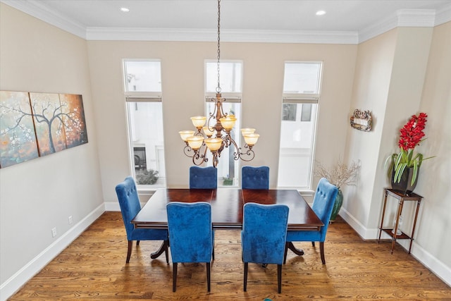 dining room featuring hardwood / wood-style floors, a notable chandelier, and crown molding