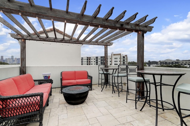 view of patio / terrace with a bar, an outdoor hangout area, and a pergola