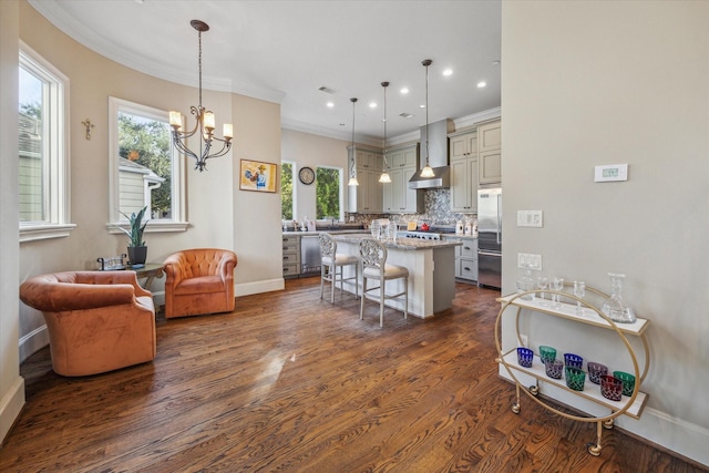 kitchen with hanging light fixtures, a breakfast bar, a center island, and stainless steel appliances