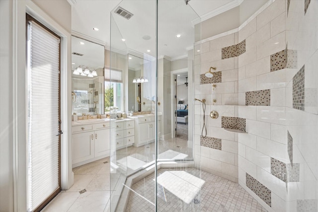 bathroom with tile patterned flooring, vanity, a tile shower, and crown molding