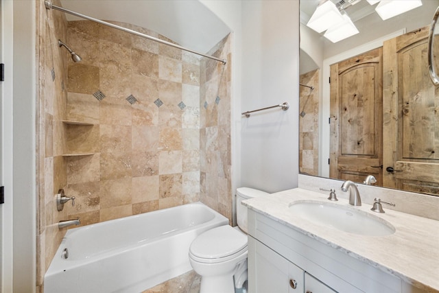 full bathroom with vanity, toilet, and tiled shower / bath