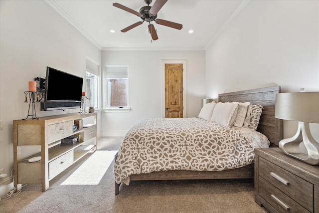 carpeted bedroom featuring ceiling fan and crown molding