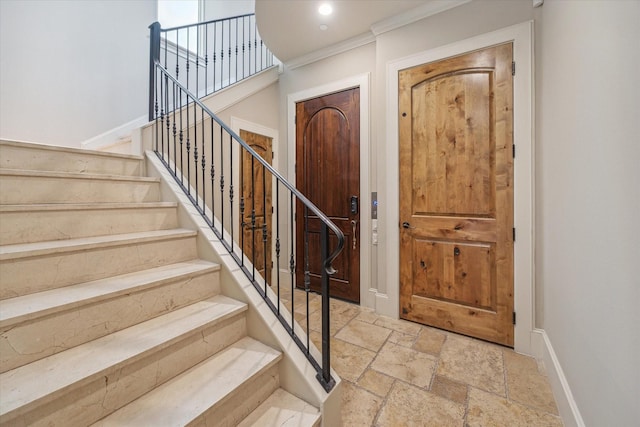 foyer entrance featuring ornamental molding