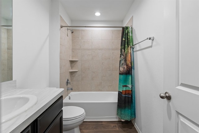 full bathroom with vanity, toilet, hardwood / wood-style floors, and shower / bath combo