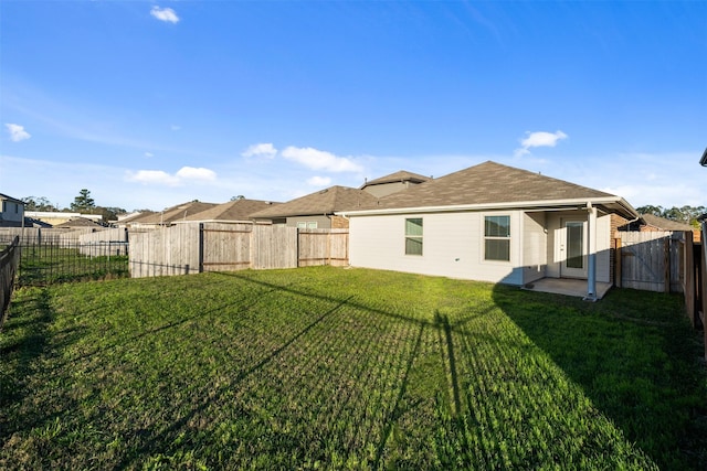 rear view of property featuring a yard