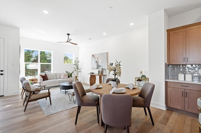 dining space featuring light wood-style flooring, baseboards, and recessed lighting