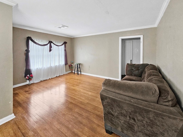 living room with hardwood / wood-style floors and crown molding