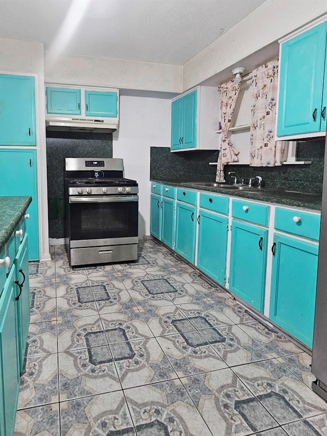 kitchen with stainless steel range oven, blue cabinets, and sink