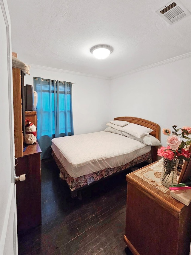 bedroom with crown molding and dark wood-type flooring