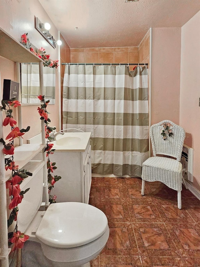 bathroom with vanity, a textured ceiling, toilet, and a shower with shower curtain