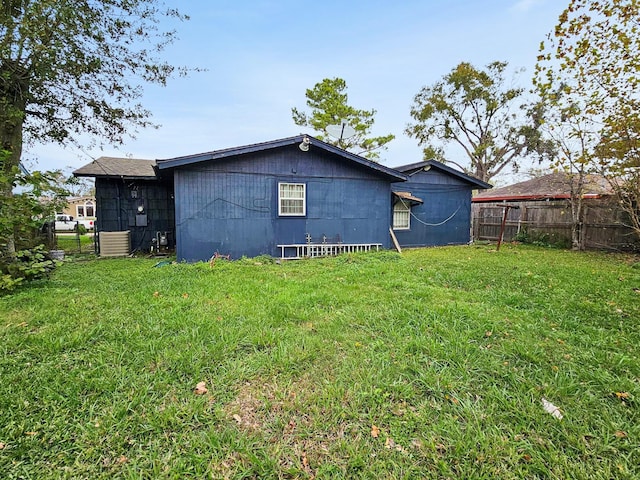 rear view of property with a lawn