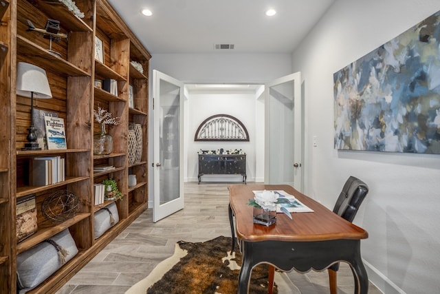 office with light hardwood / wood-style flooring and french doors