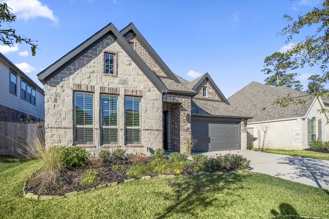 view of front of property with a garage and a front yard