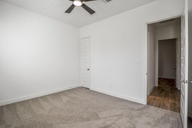 carpeted spare room with ceiling fan