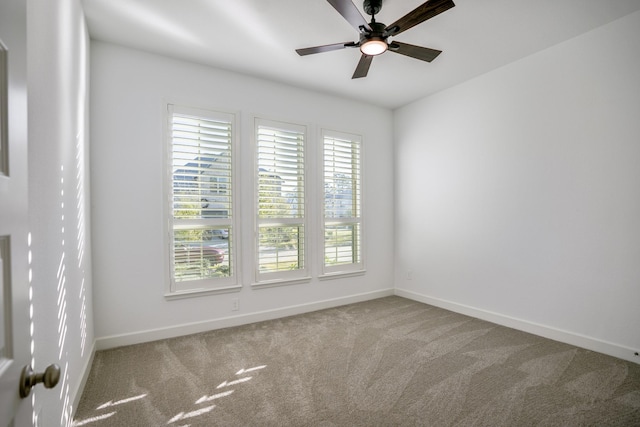 carpeted spare room with ceiling fan