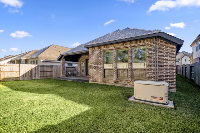 back of property featuring a patio and a lawn