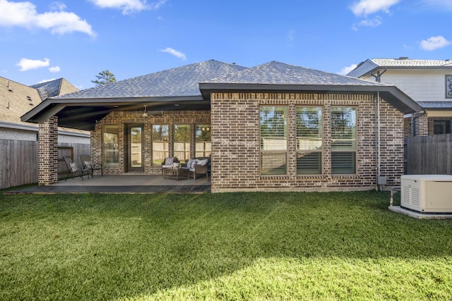 rear view of house featuring a patio and a lawn