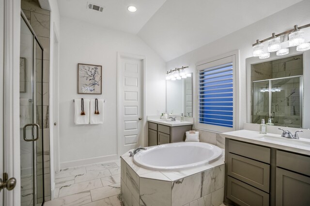 bathroom featuring separate shower and tub, vanity, and vaulted ceiling