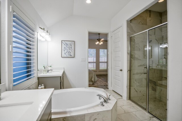 bathroom with separate shower and tub, vanity, and vaulted ceiling