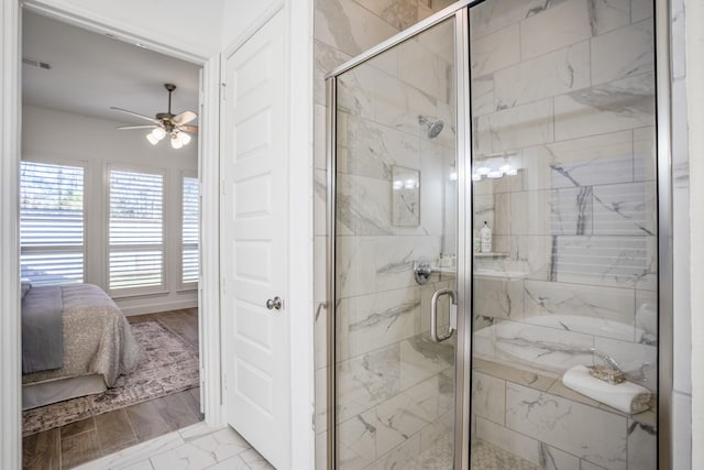 bathroom with ceiling fan and a shower with shower door