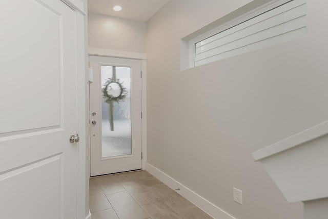 doorway to outside with light tile patterned flooring