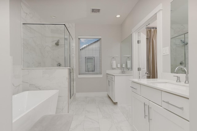 bathroom with shower with separate bathtub and vanity