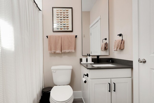 bathroom featuring vanity and toilet