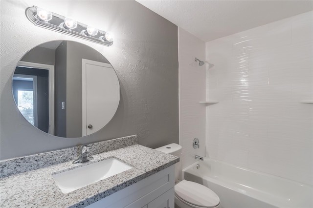 full bathroom featuring vanity, a textured ceiling, tub / shower combination, and toilet