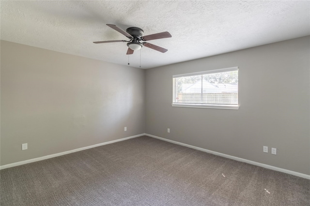 carpeted spare room featuring ceiling fan and a textured ceiling