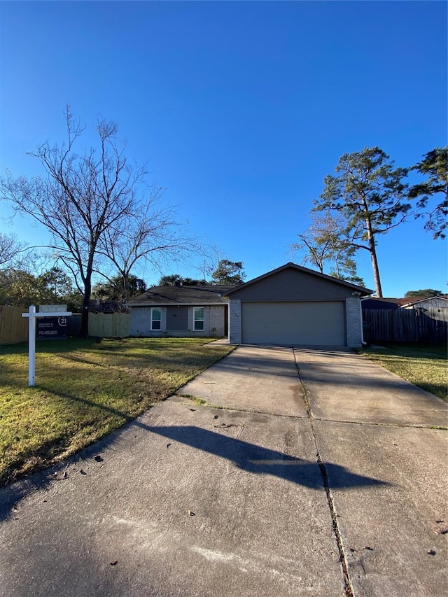 single story home with a garage and a front yard