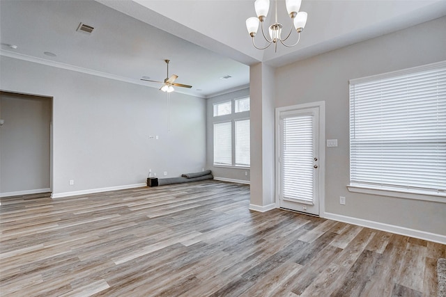 unfurnished living room featuring crown molding, ceiling fan with notable chandelier, and light wood-type flooring