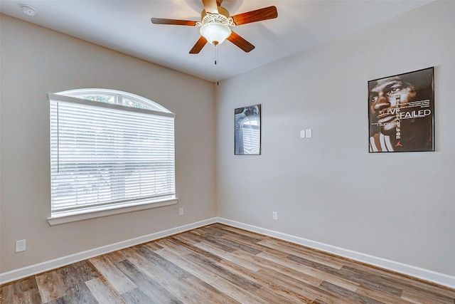 spare room with ceiling fan and light wood-type flooring