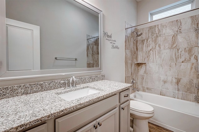 full bathroom featuring hardwood / wood-style floors, vanity, toilet, and washtub / shower combination