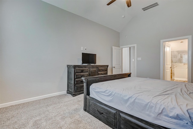 bedroom with connected bathroom, light colored carpet, high vaulted ceiling, and ceiling fan