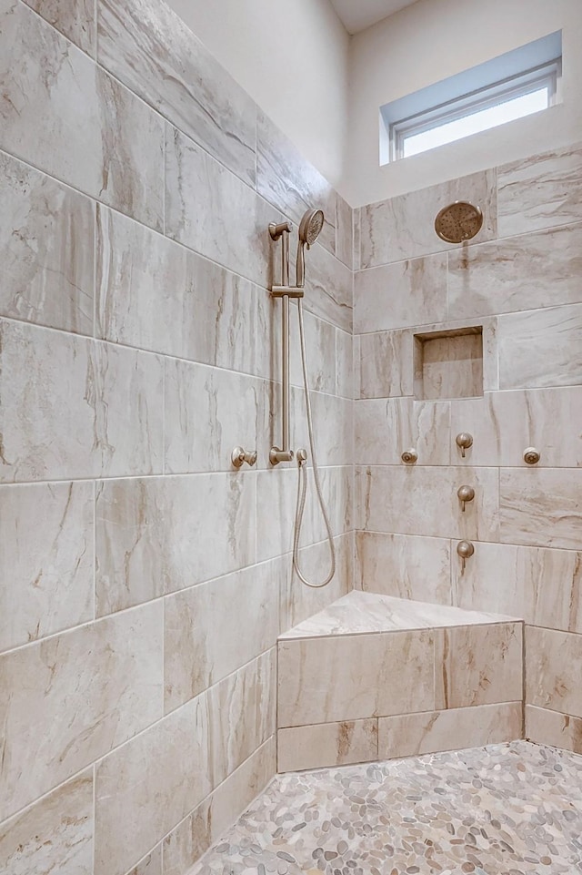 bathroom with tiled shower