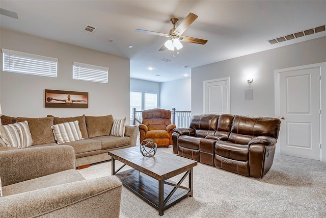 living room featuring ceiling fan and light colored carpet