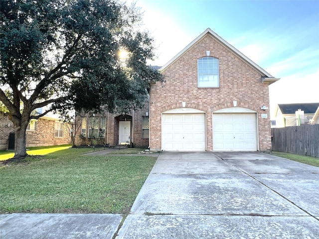 front of property with a front yard and a garage