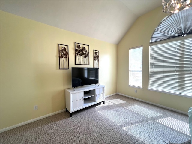 unfurnished living room featuring lofted ceiling, light carpet, and an inviting chandelier