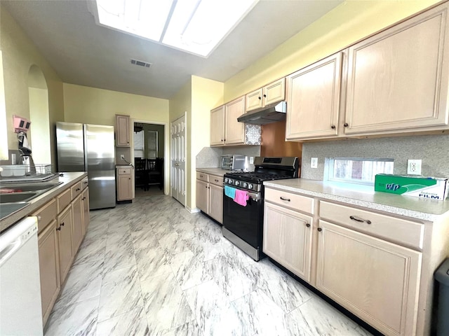 kitchen with light brown cabinetry, backsplash, stainless steel appliances, and sink