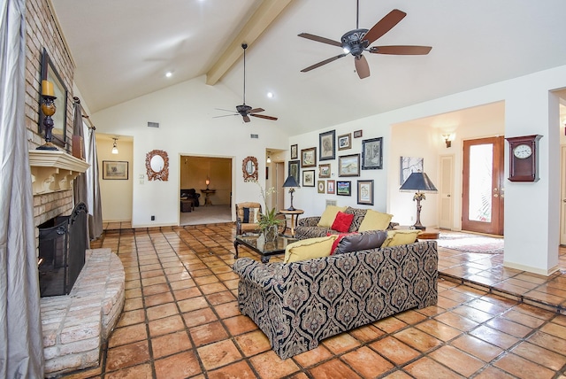 tiled living room with beamed ceiling, high vaulted ceiling, a brick fireplace, and ceiling fan