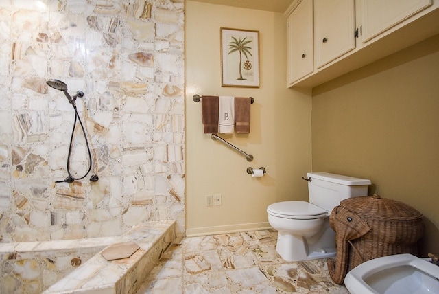 bathroom with a shower with curtain, toilet, sink, and a bidet