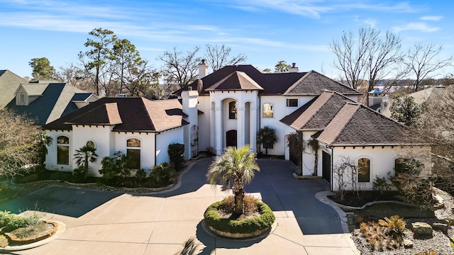 french country home featuring a garage