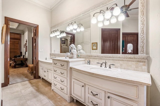 bathroom with tile patterned flooring, vanity, tasteful backsplash, and crown molding