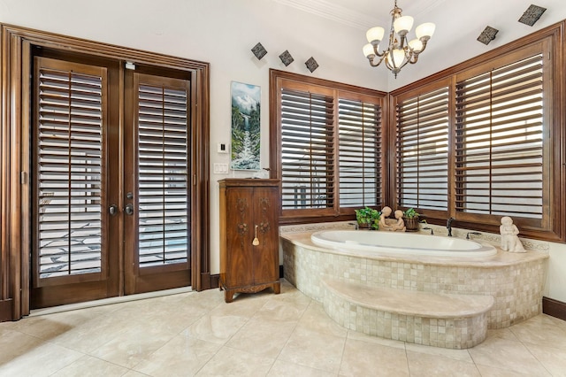 bathroom featuring french doors, an inviting chandelier, tile patterned floors, tiled tub, and ornamental molding